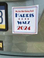 A red, white, and blue elect Harris/Walz car magnet